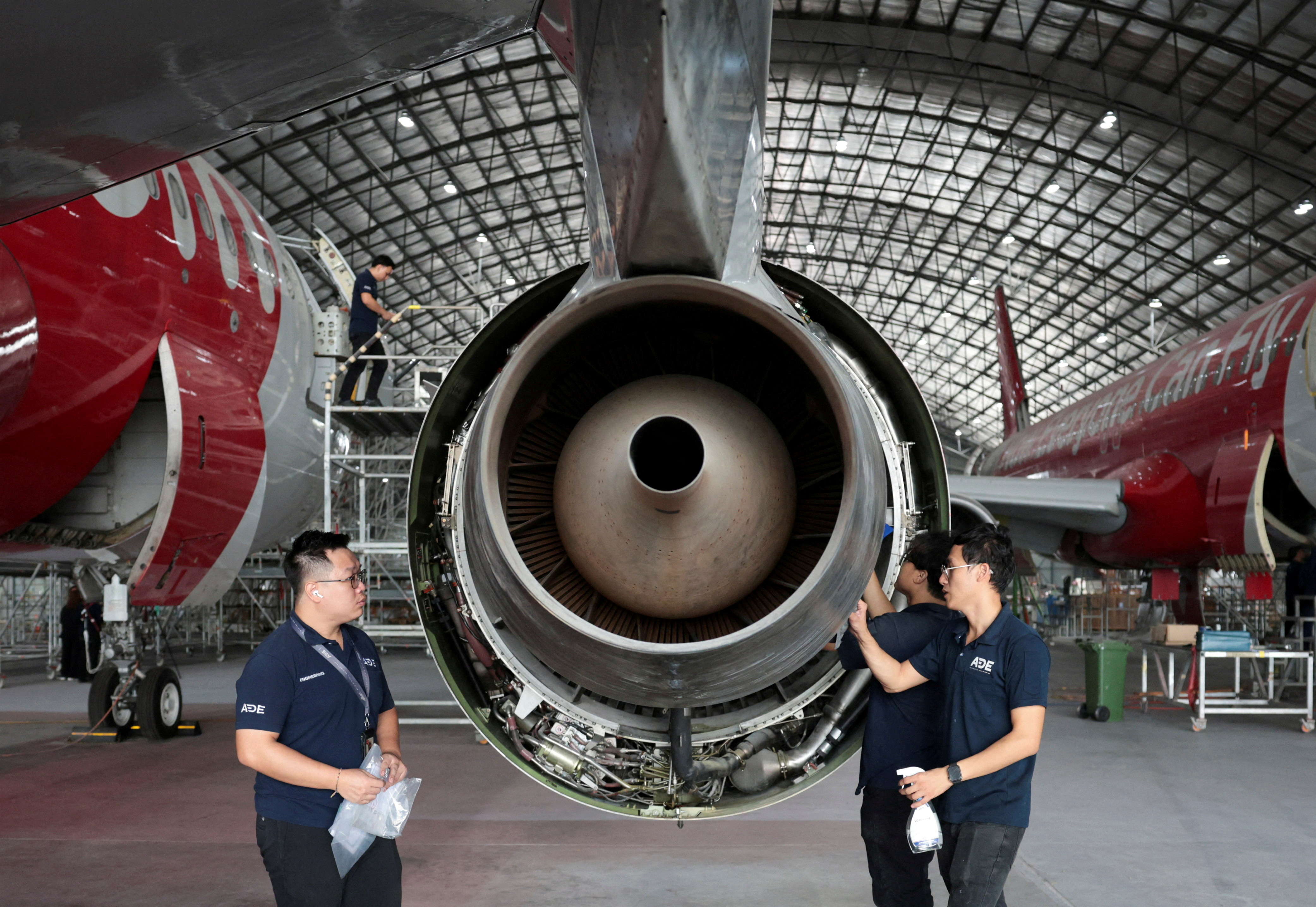 Aircraft engineers performing maintenance in a hangar